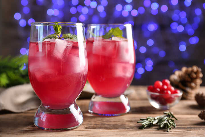 Cranberry drink in tumblers with ice and mint