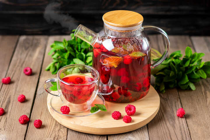 Alcohol free raspberry drink in a glass teapot, ready to be poured